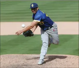  ?? PHOTO BY JOHN MEDINA ?? Rio Gomez delivers a pitch during the A's spring training game against the Columbian national team at Hohokam Stadium on Wednesday.