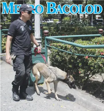  ?? ARCHIE REY ALIPALO/PN ?? A Philippine Air Force officer and a K9 dog patrol the vicinity of the venue of the recent ASEAN meeting in Bacolod City. Amid bomb hoaxes early this year, some officials believe the local police should have their own K9 unit.