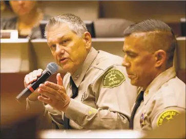  ?? Al Seib Los Angeles Times ?? L.A. COUNTY Sheriff’s Chief John Benedict, left, and Capt. Robert Lewis address a civilian oversight commission Thursday. They denied that race factors in to traffic stops and criticized part of The Times’ reporting.