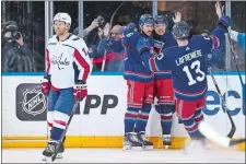  ?? SETH WENIG/AP PHOTO ?? New York Rangers wing Artemi Panarin, second from right, celebrates his goal with teammates during the first period of Sunday’s game against the Washington Capitals in New York.