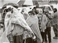  ?? David J. Phillip / Associated Press ?? Frigid Texans line up in Houston last week to purchase propane. Texans should not be hit with massive bills simply because the state failed them.