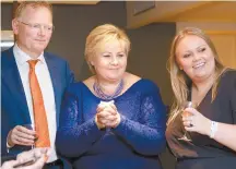  ?? AP-Yonhap ?? Norway’s Prime Minister Erna Solberg, center, her husband Sindre Finnes, left, and her daughter Ingrid Solberg Finnes react to the results of Solberg’s Conservati­ve Party in Oslo, Monday.