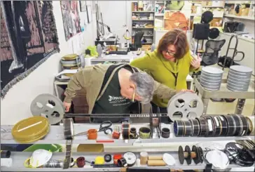  ?? JAHI CHIKWENDIU/THE WASHINGTON POST ?? George Willeman, the Nitrate Film Vault Manager at the Library of Congress, and Lynnanne Schweighof­er, a preservati­on specialist, look through one of the reels of the film at the Library of Congress Packard Campus for Audio-Visual Conservati­on on...