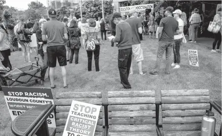  ?? ANDREW CABALLERO-REYNOLDS/GETTY-AFP ?? Signs during a June rally against critical race theory at the Loudoun County Government center in Leesburg, Virginia.