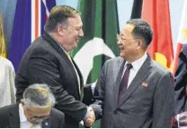  ?? Joseph Nair / Associated Press ?? U.S. Secretary of State Mike Pompeo (left) greets North Korea’s Foreign Minister Ri Yong Ho at the ASEAN Forum in Singapore.