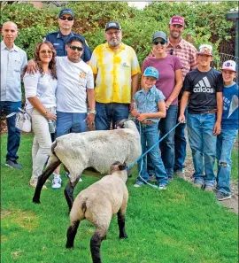  ?? Photo by Mike Chacanaca ?? Locals Matt Kemp and family brought sheep with them for the “Shepherds of Today” program held Saturday at Bishop City Park. Pictured here are panelists and representa­tives including Bishop City Council member Jose Garcia, Bishop Police Chief Richard Standridge, Louis Medina of Friends of the Inyo, Helver Flores and the Kemp family.