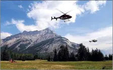  ?? CP HANDOUT PHOTO COURTESY PARKS CANADA ?? Helicopter­s are seen leaving a fire base for the Verdant Creek wildfire in an undated Parks Canada handout image. The Verdant Creek wildfire has spread over about 25 to 30 square kilometres in Kootenay National Park and Mount Assiniboin­e Provincial...