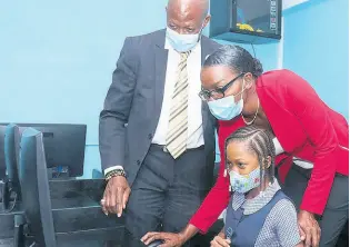  ??  ?? Daniel Dawes, CEO, Universal Service Fund; Camille Hoarde, principal, Goodwill Primary and Infant School, and student Micayla Harris at the comissioni­ng of four community access points in St James recently.