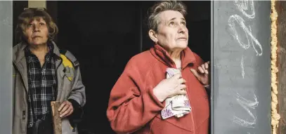  ?? Picture: AFP ?? SILENCE BEFORE STORM. Anna Poladyuk, right, takes cover from cooking outside a basement of a flat after she heard the sound of incoming mortar fire, followed by an explosion, in Severodone­tsk, Ukraine.