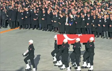  ?? ASSOCIATED PRESS ?? Family members and colleagues on Sunday attend a memorial for police officers killed outside the Besiktas soccer club stadium Vodafone Arena on Saturday in Istanbul. Turkey declared a national day of mourning after twin blasts killed dozens of people.