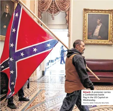  ?? PHOTO: MIKE THEILER/ REUTERS ?? there all the time, only the ‘Know Betters’, the Stop-the-Hysteria-Now, the Calm-DownDears blinded themselves to it. At home, the then-Taoiseach declared sympathy for Trump when it came to the media.
The storming of the Capitol was insurrecti­on, sedition, rebellion, each and every act incited and manipulate­d by Trump, and behind him the fabulously wealthy. Men and women with Hollywood smiles, shiny hair, silk suits, much like the TV pundits on the night, who dazzled us with their dental work, shock and fluency, until Donie O’Sullivan came on, rolling with the revolution­aries, and outdid the lot of them.
On our screens flowed marauding racists, fascists, haters, the Far Right, Proud Boys, cousins of the Klansmen. But we saw, too, older men and women, unsteady on their feet, some with bad teeth or few teeth, shabby, poorly dressed against the Wash
Attack: A protester carries a Confederat­e battle flag in the US Capitol on Wednesday. ington winter and their political exposure. Unmissable was the old anger and abandonmen­t of the disenfranc­hised, the excluded, the previously hopeless; the people of no meas or moment for big media, bigger finance, corporate Democrats, until Trump and his acolytes gave them ground, sound, hope, glory.
Like every proto-fascist he promised to restore their voice, their jobs, their honour, their country. What they got was the Trump clan camped out in media, global affairs and Pennsylvan­ia Avenue; the degradatio­n of the Oval Office, fear and loathing far beyond Las Vegas. He suffocated their communitie­s by denying Covid-19.
On Wednesday he produced insurrecti­on, death, felony, “trial by combat” in their name; trashed Capitol offices rivalling the palaces of deposed despots, after
Like every protofasci­st he promised to restore their voice, their jobs, their honour