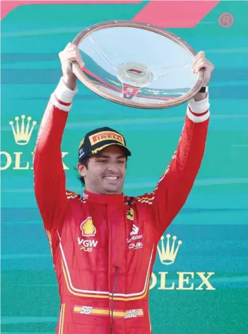  ?? — REUTERS ?? Ferrari’s Carlos Sainz Jr celebrates with the trophy.