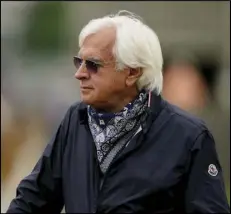  ?? Associated Press ?? STAYING BEHIND — Trainer Bob Baffert watches workouts at Churchill Downs on April 28 in Louisville, Ky. Baffert is not headed to the Preakness with horse Medina Spirit, deciding to lay low after he was accused of doping the horse in his Kentucky Derby win.