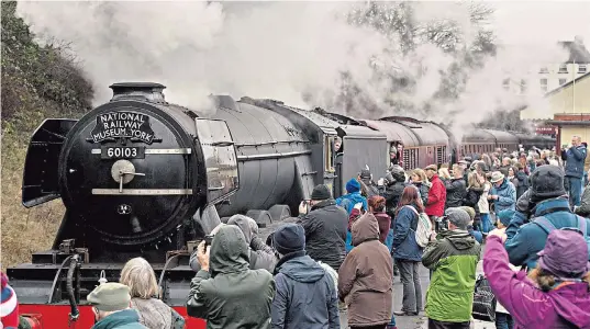  ??  ?? Crowds mass along the route of the East Lancashire Railway, above, as the train made its way at a leisurely 25mph between Bury and Rawtenstal­l