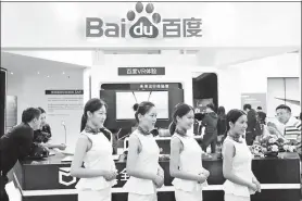  ?? A QING / FOR CHINA DAILY ?? Baidu employees pose for a photograph at the company’s booth during a high-tech exhibition inBeijing.