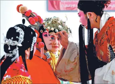  ?? MOU YU / XINHUA ?? Performers prepare to go on stage in a village in Haixing county, Hebei province, on Wednesday. The event featuring a local opera style in Hebei, was held to mark the upcoming Lantern Festival, which falls on Saturday. The opera was included on the...