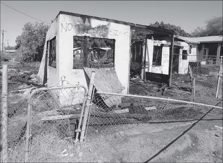  ?? Buy these photos at YumaSun.com PHOTOS BY RANDY HOEFT/YUMA SUN ?? A FEW STANDING WALLS ARE ALL THAT REMAIN OF A VACANT HOME AT 501 FIRST ST., IN WINTERHAVE­N, following a devastatin­g fire early Thursday morning. The home on the right was also damaged in the blaze.