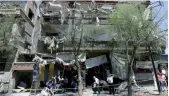  ??  ?? Des Syriens dans les décombres après l’attentat-suicide dans le quartier de la place Tahrir, dans l’est de la capitale Damas, où un kamikaze a fait exploser son véhicule hier
