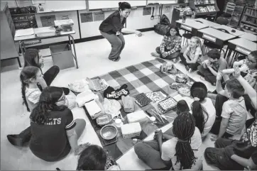  ?? Herald photo by Tijana Martin ?? Mandy Sandbach from the Lethbridge Sustainabl­e Living Associatio­n presents “Waste and Our World” to Grade 4 students at Mike Mountain Horse School on Tuesday as part of the Alberta Science Network “Scientists and Engineers-inthe-Classroom” program....