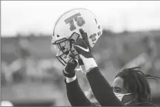  ?? ASSOCIATED PRESS ?? A MARSHALL PLAYER POINTS to a “75” decal after the team’s win over Middle Tennessee during a game Saturday in Huntington, W.Va.