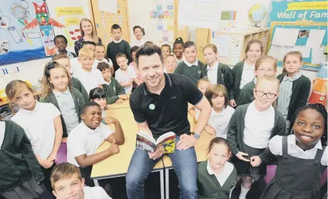  ??  ?? Children’s author Guy Bass reading stories to Year 4 pupils at Woodston Primary School