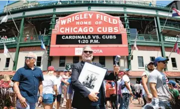  ?? CHRIS SWEDA/CHICAGO TRIBUNE PHOTOS ?? Singer Sam Fazio stands outside of Wrigley Field in Chicago on July 21.