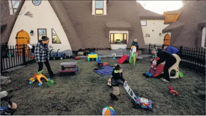  ?? CP PHOTO ?? Daycare workers and kids play outside Fable Child Care Centre in Morinville, Alta.