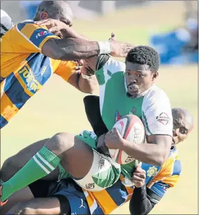  ?? Picture: FREDLIN ADRIAAN ?? NO WAY THROUGH: Spring Rose’s Luvuyo Nxeba is tackled during their match against East London Police at the weekend