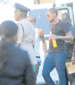  ?? FILE ?? Adidja Palmer, more popularly know as Vybz Kartel, making his way into the Home Circuit Court for sentencing in 2014.