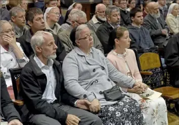  ?? Lake Fong/Post-Gazette ?? Marian Mast, right, wife of Jeriah Mast, a former missionary for Christian Aid Ministries, and other supporters listen inside the Holmes County Courthouse during the sentencing.