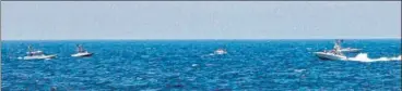  ?? AFP ?? Iranian IRGC attack craft, a type of speedboat armed with machine guns, are seen conducting manoeuvres while operating in close proximity to US naval vessels transiting the Strait of Hormuz.