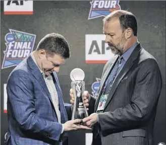  ?? David J. Phillip / Associated Press ?? Texas Tech basketball coach Chris Beard, left, is presented The Associated Press Coach of the Year Award by AP Sports Products Director Barry Bedlan on Thursday.