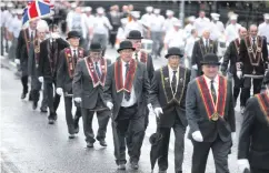  ??  ?? Sir Knights on parade in Ballymena during the Belfast Royal Black Preceptory Annual Black Saturday parade and (left) members of Newtowncun­ningham True Blues Accordion Band at the Royal Black Institutio­n parade in Limavady