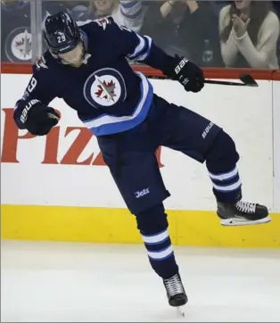  ?? JOHN WOODS, THE CANADIAN PRESS ?? Jets star forward Patrik Laine celebrates his goal in the third period in National Hockey League against the Vegas Golden Knights in Winnipeg on Friday. Winnipeg won the contest, 7-4.