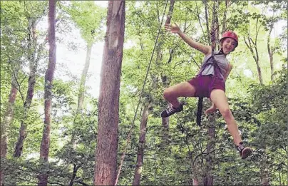 ?? SUBMITTED ?? Jessie Sheehan soars on the ROPES course during The Summer Program offered through The Adventure Group. The ROPES Program, or Rite of Passage Experience, offers participan­ts an adventure experience that requires them to develop team skills such as...