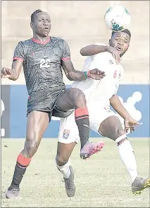  ?? (Pic: Cosafamedi­a.com) ?? Sihlangu defender Peter Dlamini (R), who earned his second cap last week in a battle with Malawi’s Flames forward Khuda Muyaba.