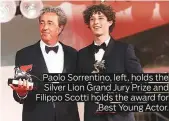  ??  ?? Paolo Sorrentino, left, holds the Silver Lion Grand Jury Prize and Filippo Scotti holds the award for Best Young Actor.