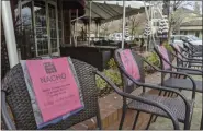  ?? MICHAEL LIEDTKE — ASSOCIATED PRESS ?? In this Dec. 21photo, empty chairs outside Crumbs restaurant in Danville, Calif., bear the names of workers who have lost their jobs during the pandemic.