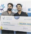  ?? ?? Junaid Rana, right, receives his Dh50 million cheque with brother Yaser