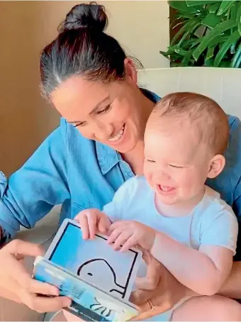  ?? AP ?? The Duchess of Sussex reading the book Duck! Rabbit! to her son Archie who celebrated his first birthday on Wednesday.