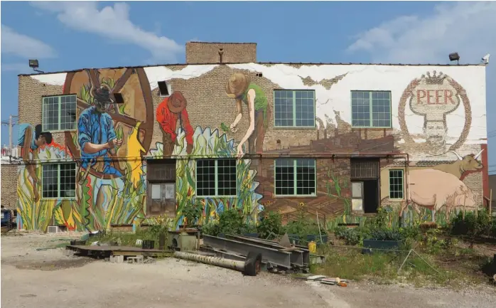  ?? PROVIDED PHOTOS ?? Joe Miller painted this mural in 2014 on a building at 1400 W. 46th St. that anchors an urban farm and food incubator called The Plant, an old meatpackin­g building back when the Chicago’s stockyards were still around.