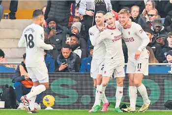  ?? — AFP photo ?? Manchester United’s striker Hojlund (right) celebrates with teammates after scoring their second goal during the English Premier League match against Luton Town at Kenilworth Road in Luton, north of London.