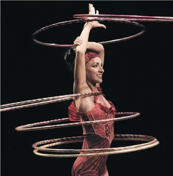  ??  ?? Sante d’Amours Fortunato, of Vancouver, performs the complex hula hoop and chandelier acts in Corteo.