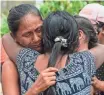  ?? LUIS ROBAYO, AFP/GETTY IMAGES ?? A woman is reunited with her family Sunday after a landslide crushed their city.