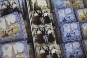  ?? ARMANDO FRANCA — THE ASSOCIATED PRESS ?? Souvenir tiles are displayed for sale at a shop in the village of Aljustrel, outside Fatima, Portugal. The tiles show Lucia Santos, Francisco Marto and Jacinta Marto, the Portuguese shepherd children who say they saw visions of the Virgin Mary 100...