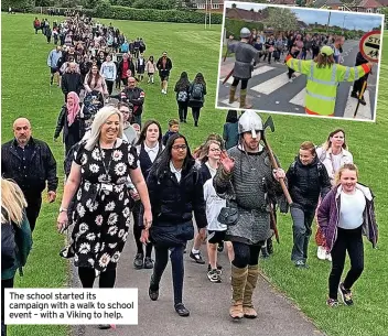  ?? ?? The school started its campaign with a walk to school event – with a Viking to help.