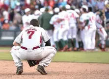  ?? Associated Press file photo ?? ■ In this June 15, 2015, file photo, Arkansas third baseman Bobby Wernes (7) watches Miami players celebrate the team’s 4-3 win in an NCAA College World Series baseball eliminatio­n game in Omaha, Neb. Arkansas will make its ninth College World Series appearance this weekend, the school’s fifth in 16 seasons under coach Dave Van Horn. The Razorbacks believe it’s time they finally won their first national championsh­ip.