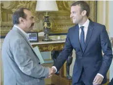  ?? — AFP ?? French President Emmanuel Macron (R) welcomes General Secretary of the General Confederat­ion of Labour union (CGT) Philippe Martinez at the Elysee Palace in Paris on Tuesday.