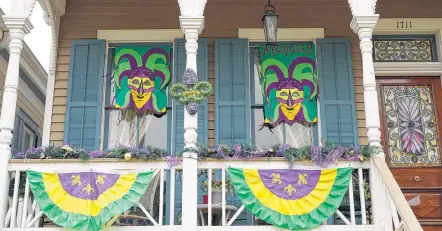  ?? Photos by Melissa Phillip / Staff photograph­er ?? A home on Ball Street in Galveston is dressed up in the gold, green and purple colors that represent Mardis Gras.