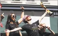  ?? Al Bello / Getty Images ?? Alex Morgan, Megan Rapinoe, and Allie Long celebrate during the U.S. Women’s National Soccer Team Victory Parade and City Hall Ceremony on Wednesday in New York.